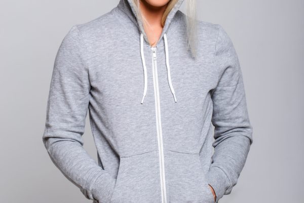 Athletic fitness woman in grey hoodie. Athletic fitness woman in grey hoodie. Studio shoot
